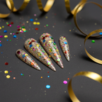 Multicolor confetti glitter nails with gold streamers on dark background